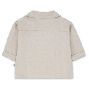 A sophisticated 1+ in the Family Jacket in a muted beige tone, showcasing its structured silhouette and high-end boutique finish.
