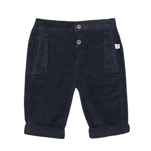Navy blue corduroy pants with button details on a white background