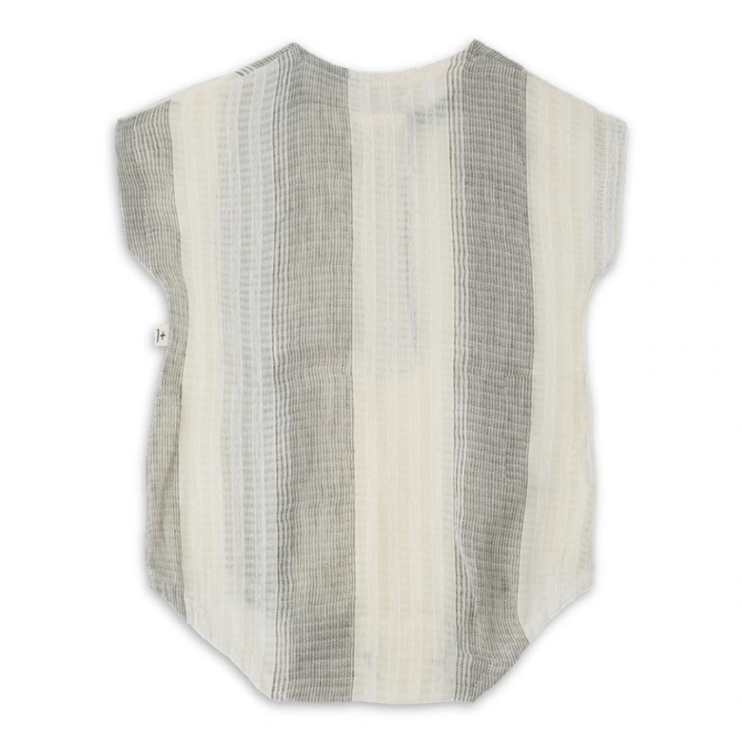 A high-end 1+ in the Family Bordils Romper in a soft neutral textured knit, featuring a modern architectural silhouette for infants.