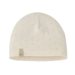Beige knit baby hat with a small label on a white background