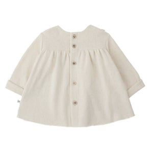 A soft, flowy 1+ in the Family TALENCE dress for babies and toddlers in a natural ecru color.