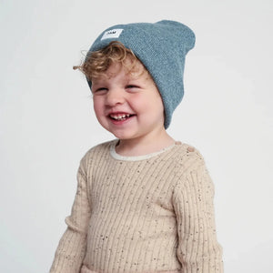 A child wearing the 7AM Enfant beanie comfortably
