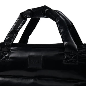 A high-resolution close-up of the polished gloss finish and interior pockets.