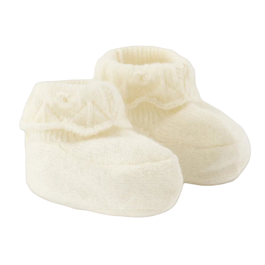 Pair of cream-colored baby booties on a white background