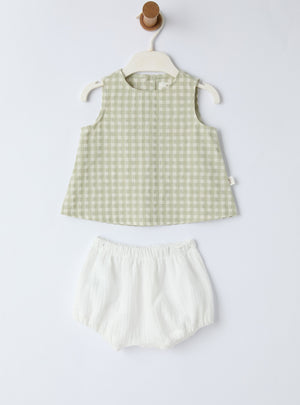 Green checkered sleeveless top and white shorts set on a white background