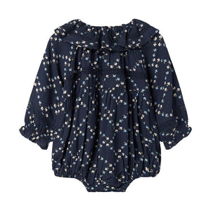 Navy blue baby romper with floral pattern on a white background