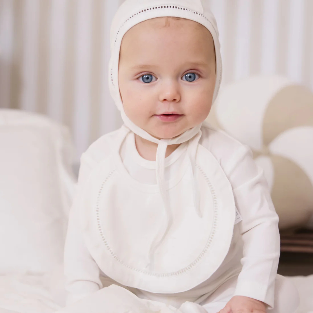 The Kipp Baby – White Bebe Bib is a charming everyday essential designed