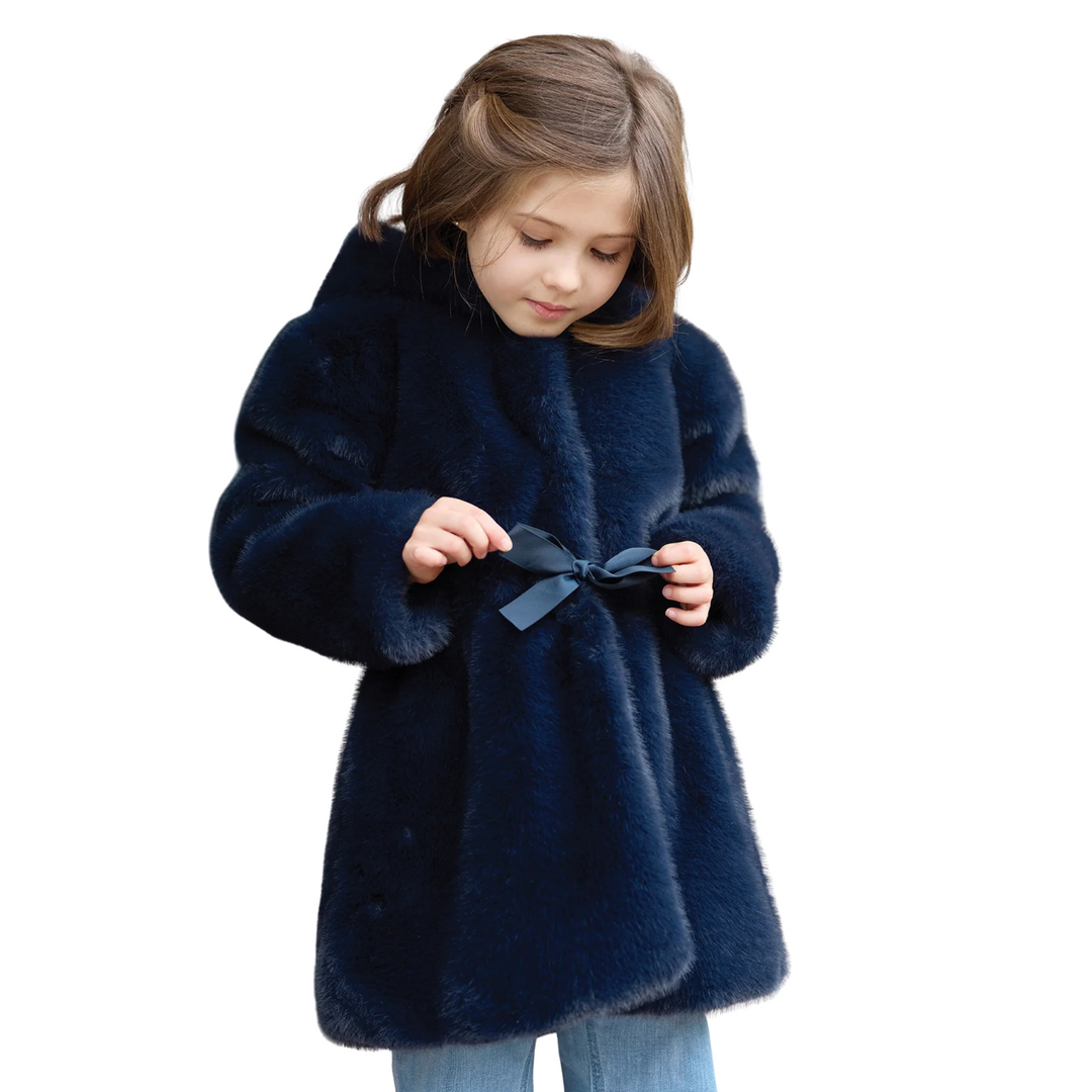 Young girl wearing a blue coat on a white background