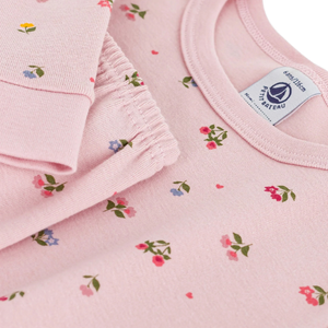 Pink children's clothing with floral pattern and Petit Bateau label