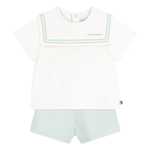 White sleeveless top with green trim and light green shorts on a white background