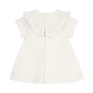 White dress with ruffled details on a white background
