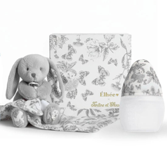 Gray plush bunny toy with a matching blanket and decorative egg on a white background