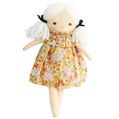 Toy doll with a floral dress on a white background
