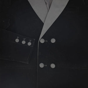 A high-resolution close-up of the plush velvet lapel and crisp taffeta texture.