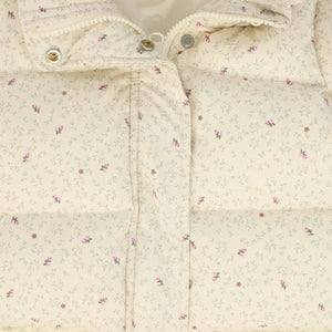 A high-resolution close-up of the vibrant floral pattern and quilted puffer texture.