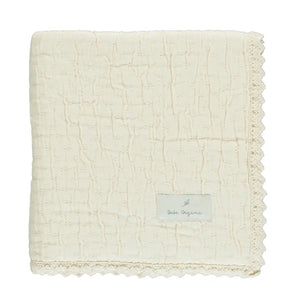A neatly folded presentation showcasing the plush chenille texture natural
