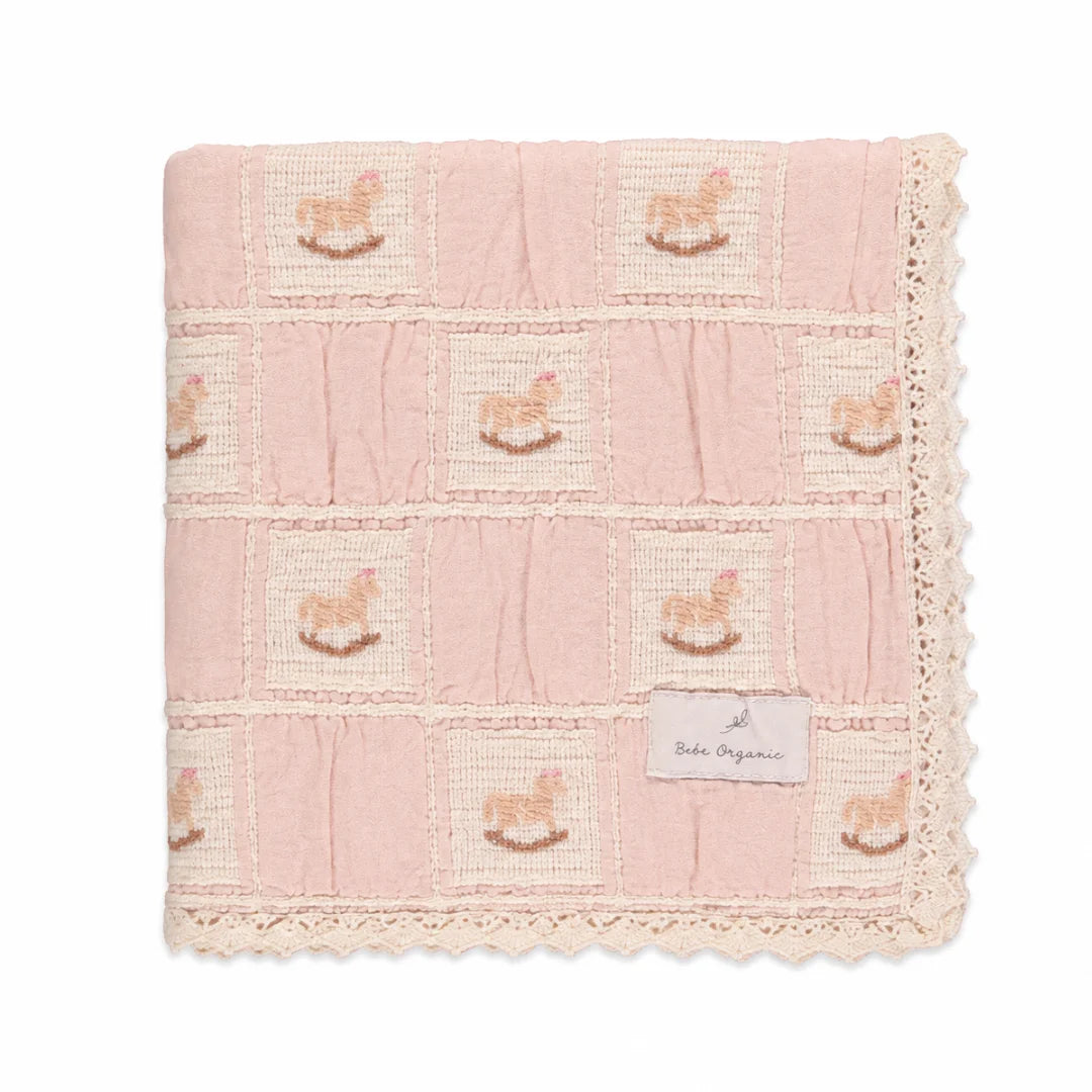A neatly folded presentation showcasing the patchwork design and lace edges mauve