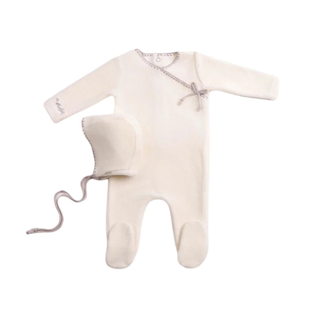 A front view of the luxurious chalk white Bee & Dee velour footie and bonnet set.