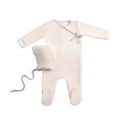 A front view of the luxurious chalk white Bee & Dee velour footie and bonnet set.
