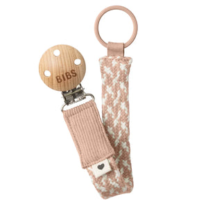 BIBS pacifier clip with pink woven strap on a white background