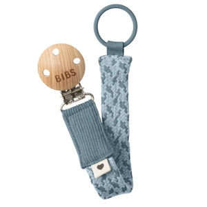 BIBS pacifier clip with wooden clip and textured blue strap on a white background