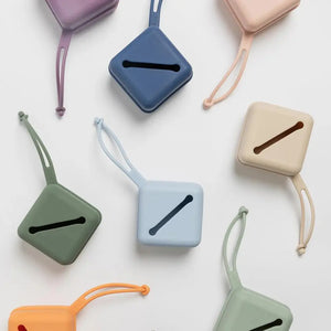 Colorful square-shaped products with straps on a white background