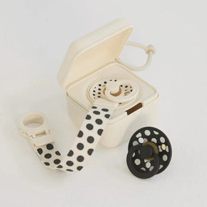 Cream-colored reel-to-reel tape recorder with polka dot strap on a light gray background