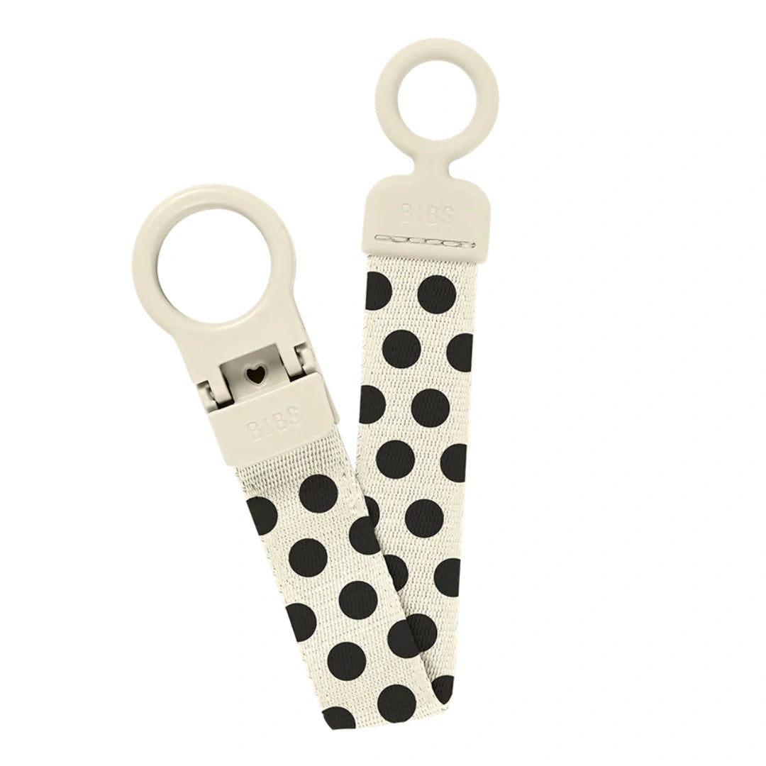 A breathtaking BIBS Studio Loop Pacifier Clip in Polka Ivory and Black, showcasing its immaculate minimalist design and secure attachment loop.