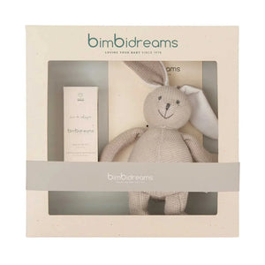 Bimbidreams baby gift set featuring a beige knitted bunny plush toy and a matching cream-colored bottle inside a cream-colored gift box with a clear window and a gray band.