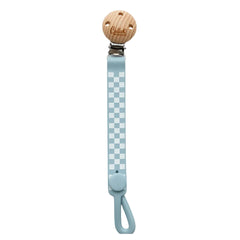 Pacifier clip with checkered strap and wooden buckle on a white background