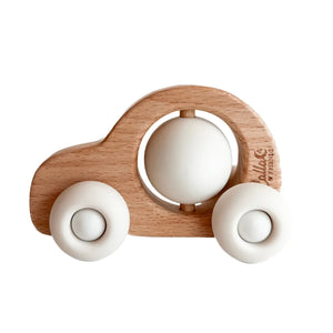 Wooden toy car with white spherical elements on a white background