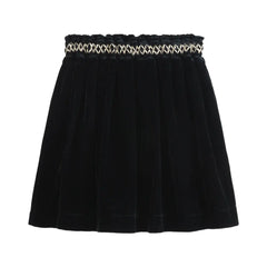 Black skirt with a decorative waistband on a white background