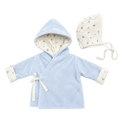 A flat-lay view of the Coton Pompom blueberry bambino jacket and bonnet set in light blue.