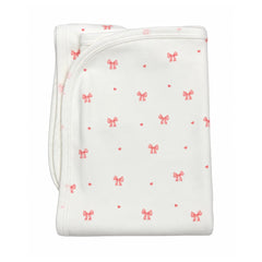 A flat-lay view of the Coton Pompom bows knit blanket in ivory.