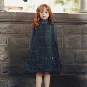A child wearing the Cottier charcoal jumper standing.