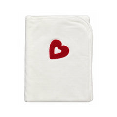 A folded white baby blanket featuring a red heart design with a white center, set against a plain white background.