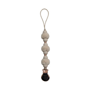 front view of the Crystal Dream pom pacifier clip in beige.