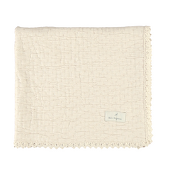Beige textured blanket with a brand label on a white background