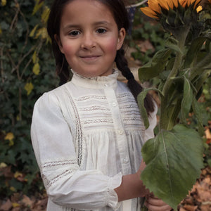 child styled in the Early Sunday Zoe ecru shirt during an outing.
