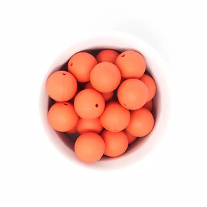 A breathtaking Limited Edition EMO & CO. Saylor Petite Pacifier Clip in vibrant Coral, highlighting its architectural silicone beads and polished clip.