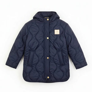 Navy quilted jacket with gold buttons on a white background