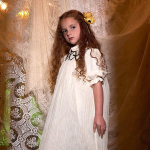 A child wearing the Francesca Guiliano formal dress gracefully during a celebration.