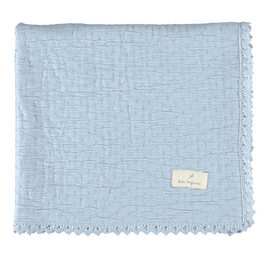 Light blue textured blanket with a brand label on a white background