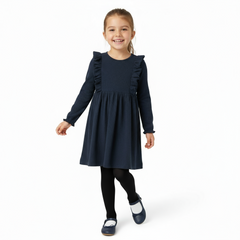 Young girl wearing a navy dress with ruffled sleeves on a white background
