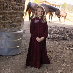 A front view of the La Nina burgundy corduroy smocked maxi holiday dress.