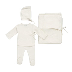A complete flatlay of the Latte Baby 4-piece embossed knit wrap, bonnet, and blanket set in white.