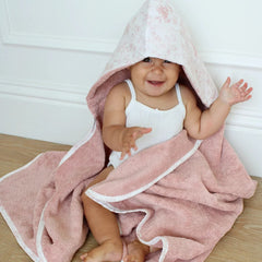 A front view of the rose-colored Little Threads toile print hooded bath towel.