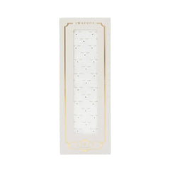 A flat-lay view of the Livly Sleeping Cutie swaddle blanket in white.