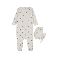 A flat-lay view of the Mema Knits blue floral printed snap back footie and bonnet set.