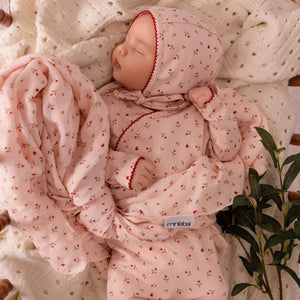 An infant styled in the Mini Label pink heart kimono set during a portrait session.